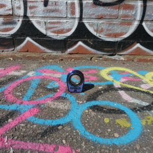 Graffiti na ścianie z kolorowym spinedem na ziemi.